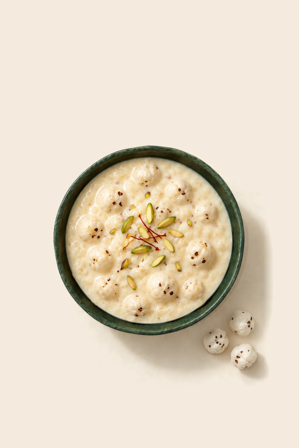 Makhana kheer with saffron in a green bowl